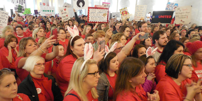 Teachers flood the West Virginia capitol Friday as part of a statewide walkout. The bunny ears refer to disparaging comments from Governor Jim Justice (Dedicated Teachers / Facebook)